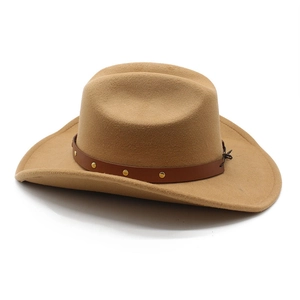Detail of camel felt cowboy hat featuring a brown leather band with golden rivets