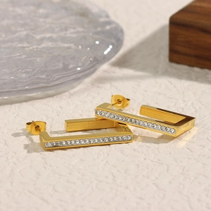 Macro shot of 18K gold plated rectangular earrings with clear zircon stones inlay