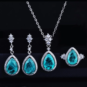 Detailed view of Paraiba style jewelry set with teardrop gemstones in a black gift box