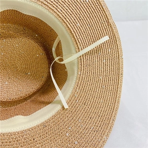Detail view of woven sun hat with silver sequins and adjustable inner sweatband