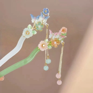 Macro shot of traditional floral and butterfly acetate hair sticks with flowing tassels