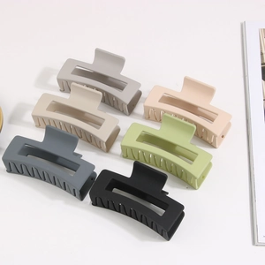 Macro view of six matte rectangular large hair claws in various neutral colors for women