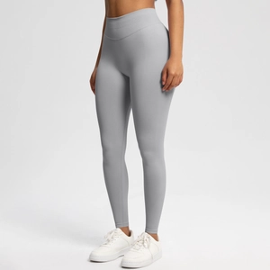 Detail view of high-waisted seamless light grey yoga pants showing stretch fabric fit