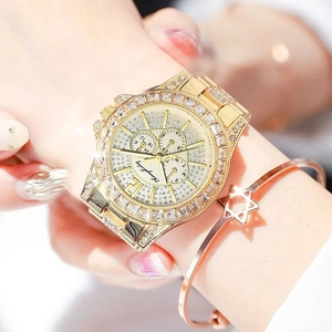 Close-up of luxury gold rhinestone watch with starry sky dial and matching star bracelet