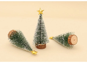 Detailed view of mini frosted pine trees with wooden bases and golden stars