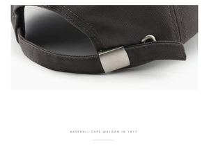 Detail of dark grey baseball cap featuring a metal buckle closure and cotton texture