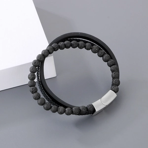 Detail of multi-layer men's bracelet with black lava stone and silver magnetic clasp