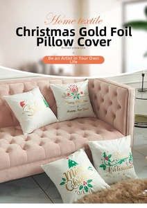 Detailed view of four white Christmas pillowcases with gold foil prints on a pink sofa
