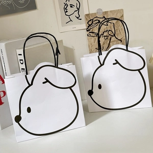 Detail of white paper gift bags with minimalist black cartoon dog and cord handles