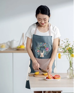 Detail of waterproof kitchen apron with hand-wiping towels and Hello Spring rabbit pattern