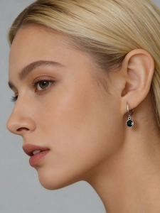 Close-up of S925 sterling silver hoop earrings with round black zircon drop pendant