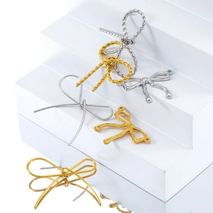 Detailed close-up of golden and silver butterfly charms on a white display stand