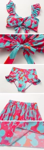 Close-up of vibrant blue and pink abstract floral print bikini with ruffle detail and sarong