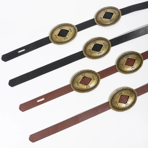 Detail of vintage waste-style leather belts with engraved metal buckles in black and brown
