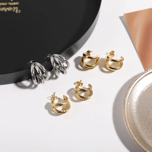Detail view of geometric mirror finish stainless steel earrings in gold and silver