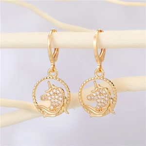 Elegant gold unicorn hoop earrings with micro-paved zircons on a white branch display