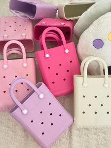 Macro detail of mini EVA beach tote bags featuring various colors and circular vent holes