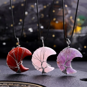 Three crescent moon crystal necklaces with tree of life wire wrap in red, pink, and purple