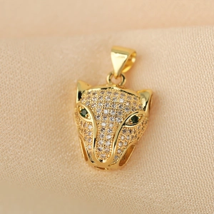 Luxurious gold leopard head pendant with sparkling white crystals and green gemstone eyes