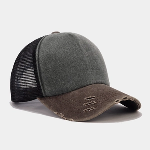 Detail of distressed brim and breathable mesh back on the two-tone trucker cap