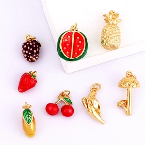 Macro view of colorful fruit charms including watermelon and strawberry for jewelry making