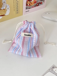 Striped pleated cotton drawstring storage bag with pink and blue vertical patterns
