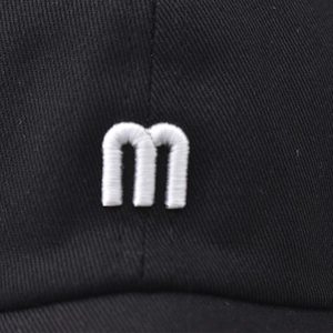Black short-brim baseball cap with white 3D embroidered M logo on twill cotton
