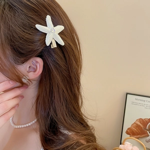 Gros plan sur la barrette étoile de mer avec cristal portée comme accessoire latéral