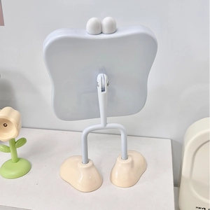 Cute white cartoon desktop makeup mirror with eye accents and beige foot-shaped base