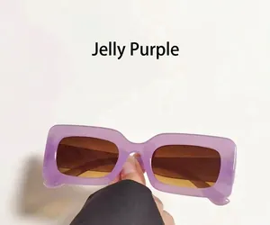 Close-up of jelly purple rectangular sunglasses with brown gradient lenses and thick frame