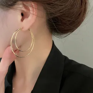 Minimalist double-layered gold hoop earrings for women with polished metal finish