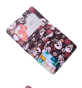 Detail view of foldable skull print wallet showing multiple card slots and ID window