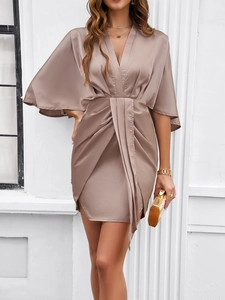 Detail of elegant satin V-neck dress with waist pleats and stylish batwing sleeves