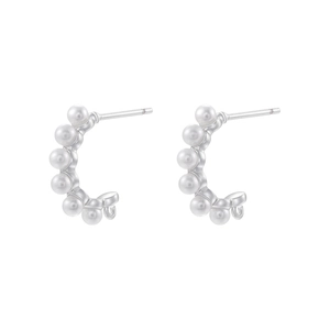 Detail view of C-shaped silver earrings featuring elegant white rice pearls with glossy finish