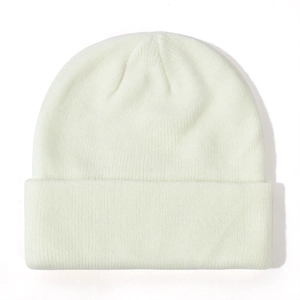 Close-up of the soft ribbed knit texture on a classic cream-white baby beanie hat.
