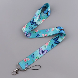 Detail of teal butterfly fabric lanyard with floral pattern and metal lobster clasp