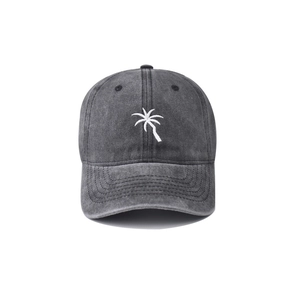 Close-up of white palm tree embroidery on a washed grey cotton baseball cap