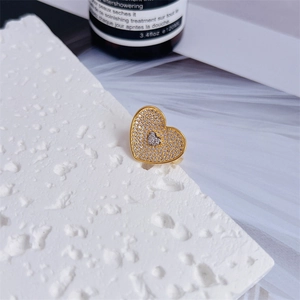 Macro shot of 18K gold plated heart ring with shimmering pavé zircon gemstones