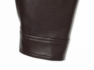 Close-up of dark brown faux leather jacket sleeve with detailed double stitching craft