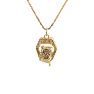 Detailed macro view of gold-plated necklace with S-letter lip-shaped pendant and cubic zirconia