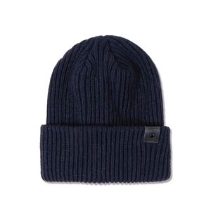 Detailed close-up of dark blue ribbed knit beanie with leather FAVORITE patch