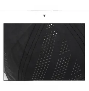 Close-up of laser-cut mesh holes on black baseball cap showing breathable fabric detail