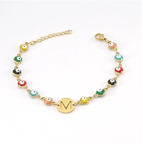 Detailed close-up of 18K gold-plated bracelet with colorful evil eye beads and 'M' pendant