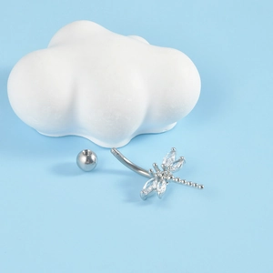Detail of silver dragonfly belly ring with zircons showing the screw ball and curved bar