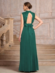Detail of sequins and open back bow on dark green sequined pleated evening gown