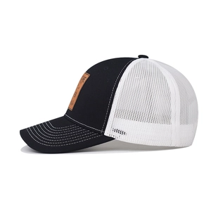 Detail of truck cap side with brown leather patch, breathable mesh and white stitching