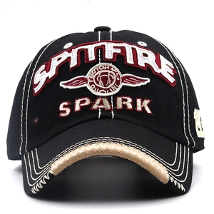 Close-up of SPITFIRE motor oil embroidery and SPARK lettering on black cotton baseball cap