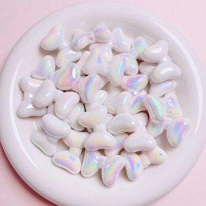 Close-up of white aurora bow beads in a dish for DIY jewelry making material