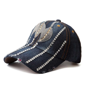 Detailed view of silver rhinestones on dark blue denim baseball cap for women