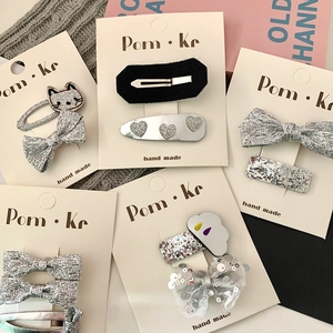 Cute cartoon cat and bow silver hair clips set with sequins on a white display card